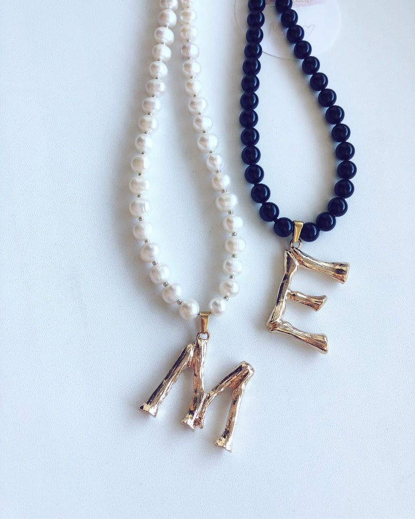 Pearl necklace with a bold letter