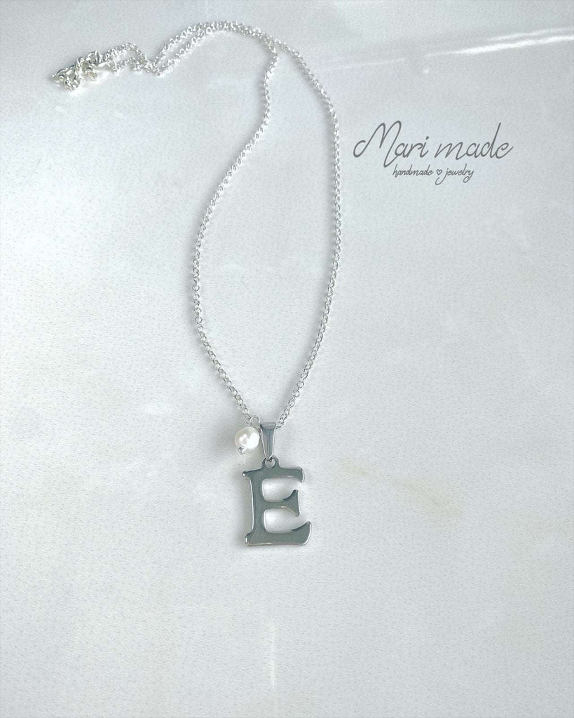 Necklace with a silver letter