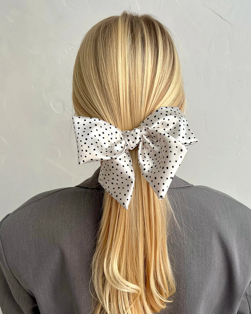 White bow barrette with black dots