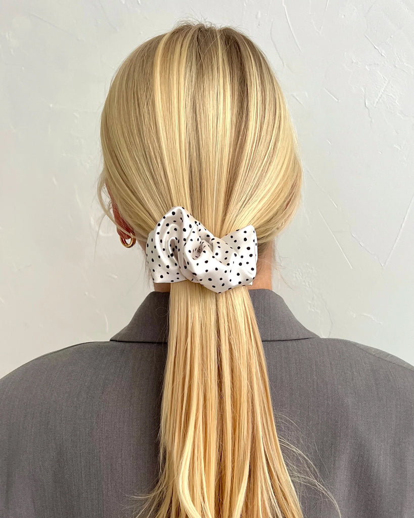 White hair clip with black dots