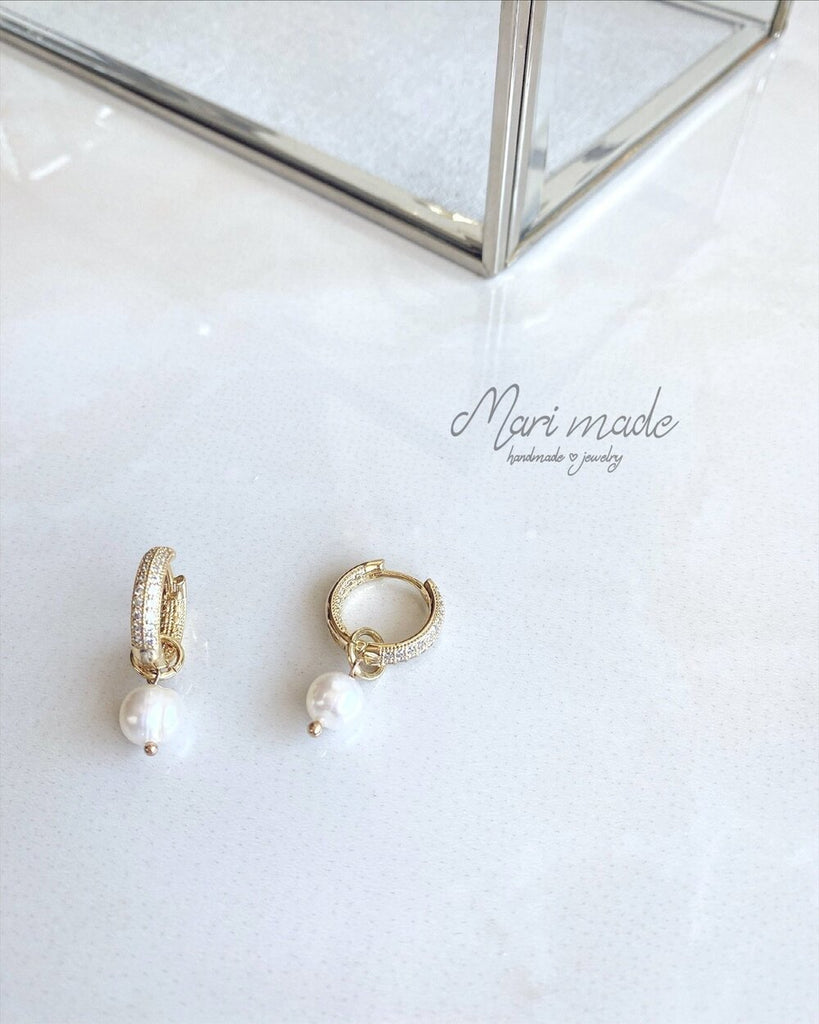 Gold sparkling earrings with a pearl