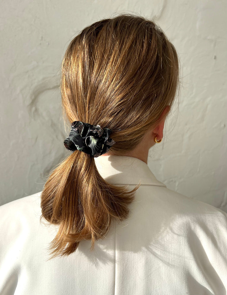 Black scrunchie holds hair firmly