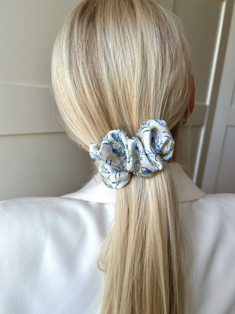 White hair clip with blue flowers