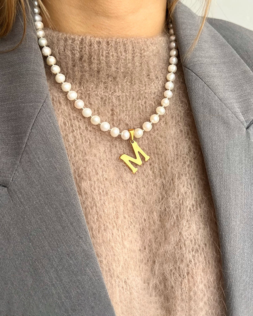 Pearl necklace with a letter pendant