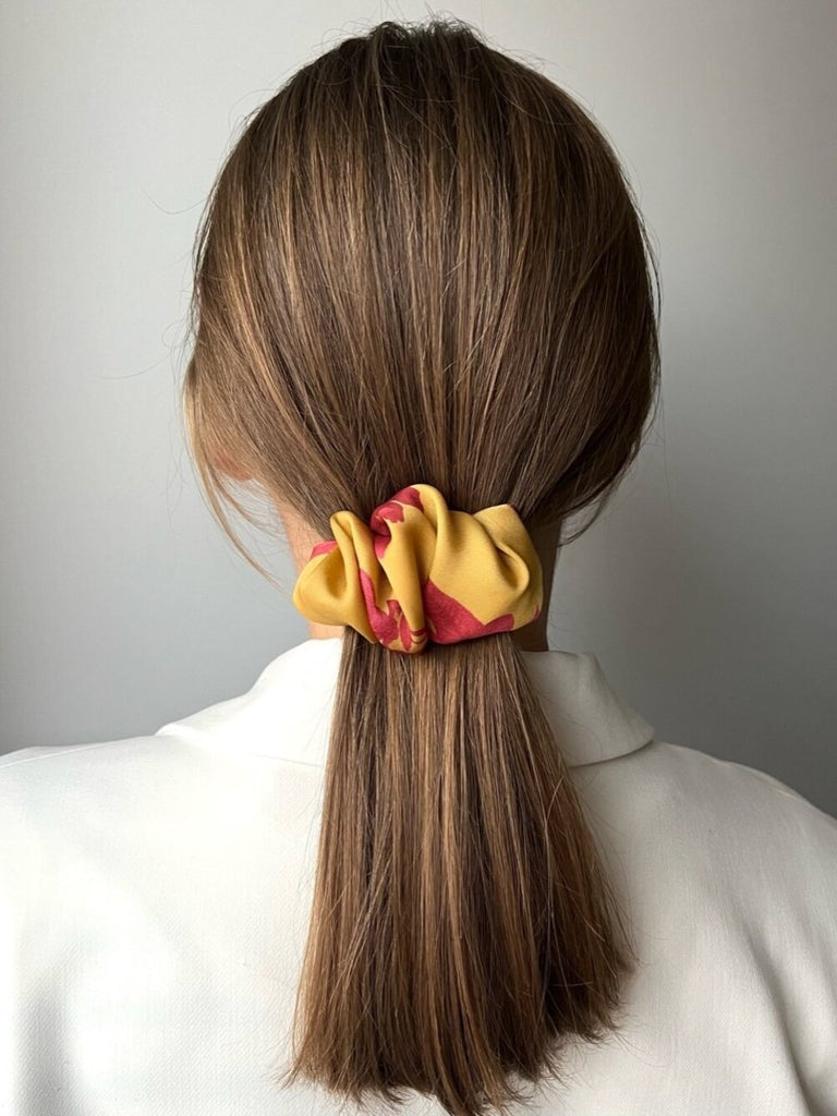 Yellow hair clip with red flowers