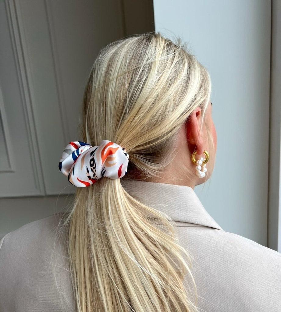White hair clip with orange and blue